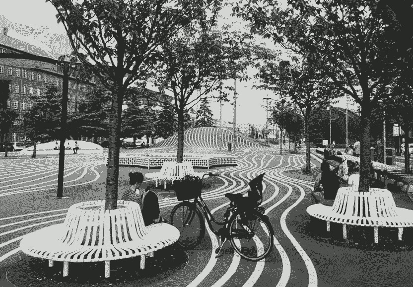 A beautiful park in Copenhagen with lines showing the proper bike pathing.